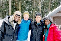 Brian Mongare (far left) and Floria Nyandaya (far right) with their hosts.